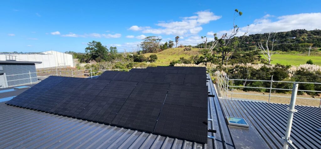 BW Henderson electrician carrying a panel across a boardwalk at an Auckland property
