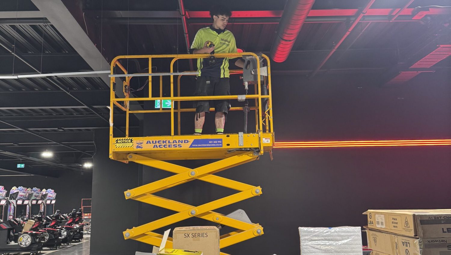 Electrical fit-out at Game On Takanini - scissor lift installation work