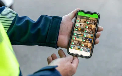 Electrician holding a phone showing a home automation app with camera feeds